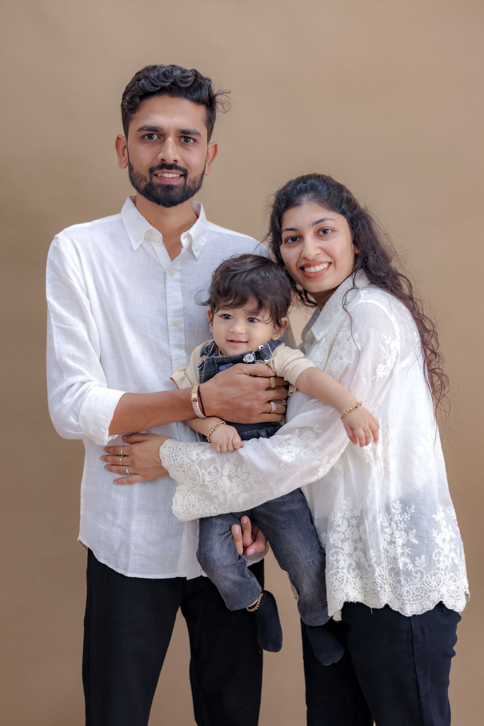 A couple holding their baby