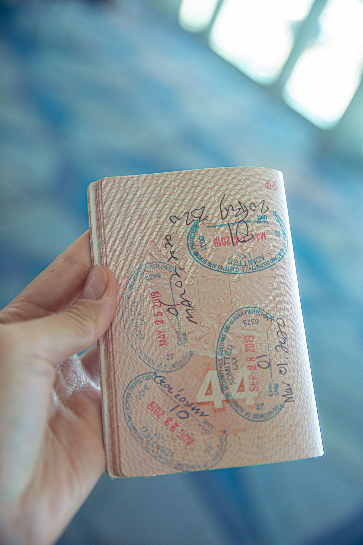 An open passport with stamps