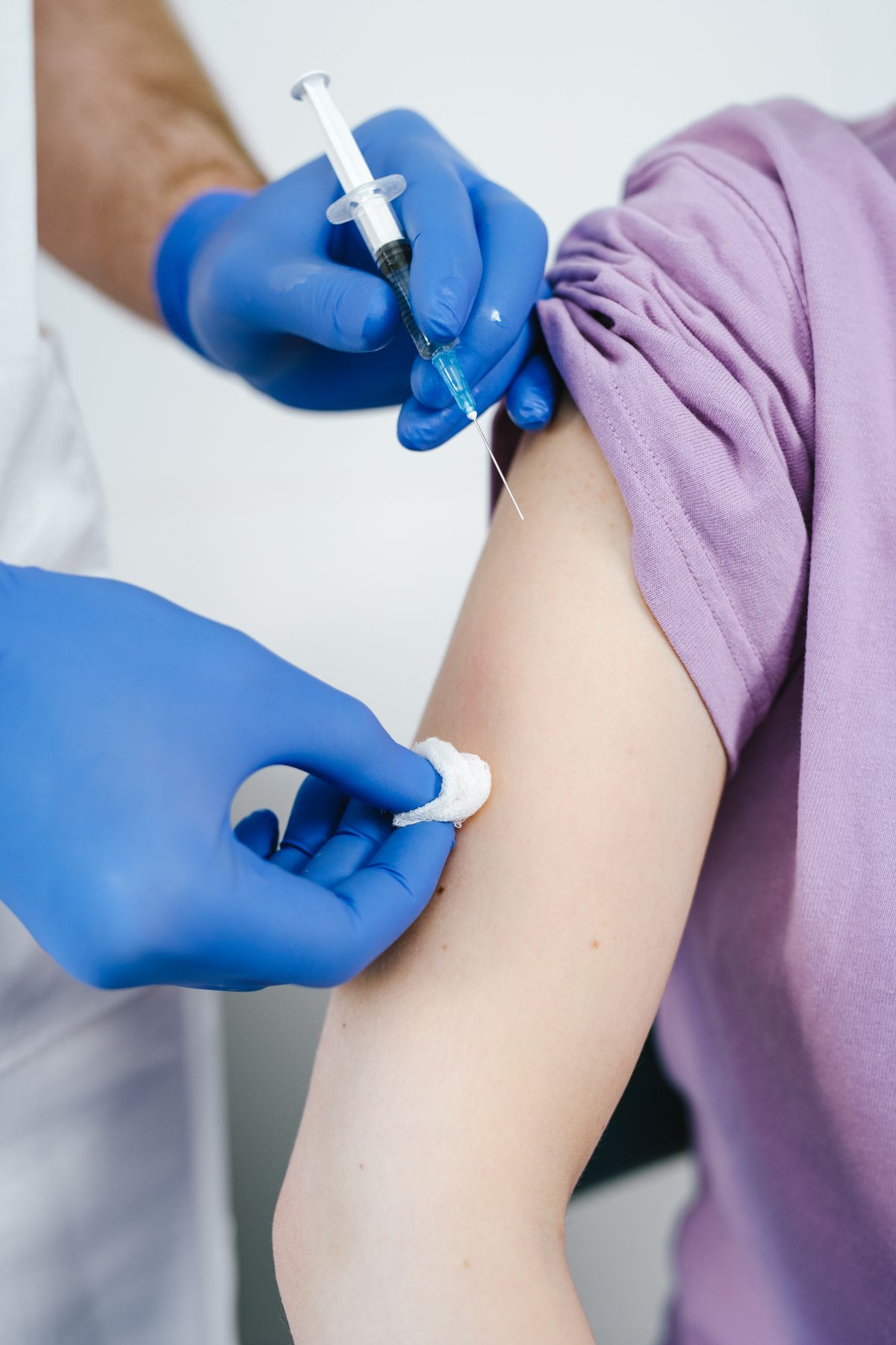 A vaccine being given in the upper arm